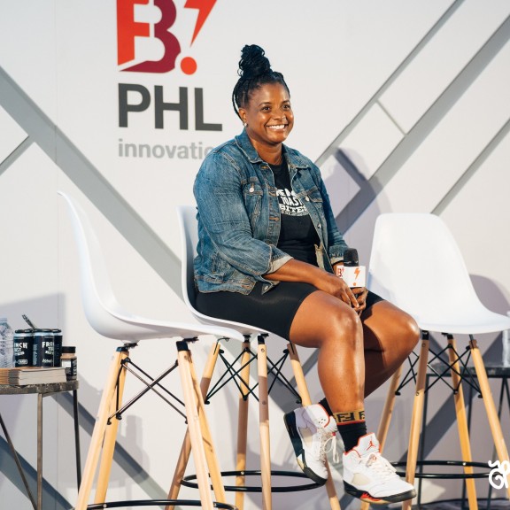 black woman with a braid top bun in a jean jacket