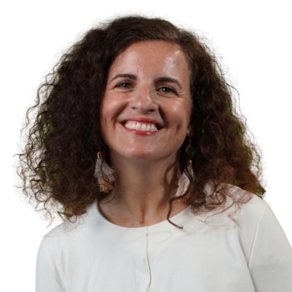 Woman with curly hair wearing a white shirt